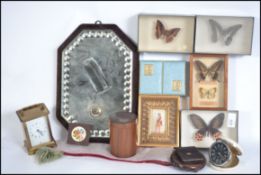 A collection of items to include taxidermy butterflies, treenware, travel clock, a gypsy mirror