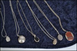 A collection of 6 ladies necklace chains with lockets / pendants. To include oval chase decorated