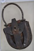 A 19th / 20th century unusual leather horse shoe shaped bag with a large hand worked iron handle?