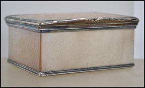 An 18th century mother of pearl rectangular snuff box, hinged  cover, engraved silver scrolling