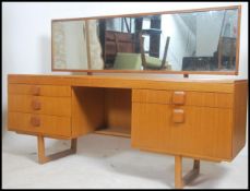 A vintage retro 20th century teak wood dressing table. Full length mirror above a series of