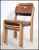 A set of 4 mid century Industrial / school hall chairs raised on yellow cream tubular metal frames