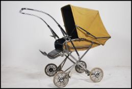 A vintage / retro 20th century Comfifolda child's pushchair, with covers and operational hood.