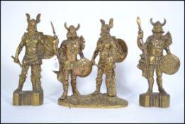 A mid century heavy brass garniture of viking figurines to include 2 single viking warriors and a