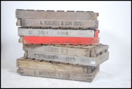 A stack of vintage Industrial apple crates. Wooden planked form with remains of paint and notation