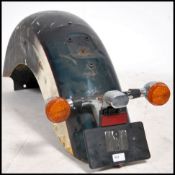 A vintage / retro 20th century motorcycle tail guard from a large motorcycle in the manner of Harley