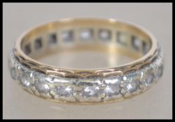 A 9ct white gold eternity ring stamped to the inside for London 1973 with makers mark for B.K.T