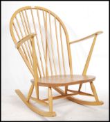 An Ercol Golden Dawn beech and elm wood Windsor / Quaker pattern rocking chair / armchair raised