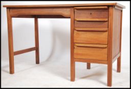 A superb mid century Danish inspired teak desk having an open kneehole recess flanked by a