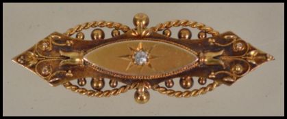 An late 19th century hallmarked 15ct yellow gold (stamped 15ct / 625 ) diamond set bar brooch.