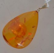 A modern Danish silver and Baltic amber pendant,  the oval cabochon 3.5cm long mounted on a gold