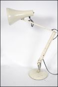 A 20th century retro Herbert Terry Anglepoise desk lamp having a circular base with conical shade in