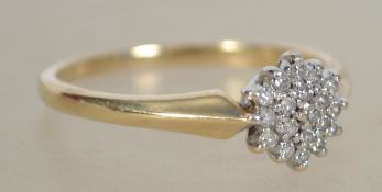 A ladies vintage 9ct gold cluster diamond ring having flower head design. Total weight 2g / Size O.