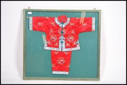 A Chinese - asiatic silk embroidered childs ceremonial gowns - dress and top being mounted and set