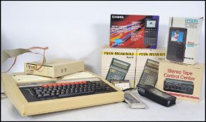 A vintage BBC Micro home computer together with a disc drive and other vintage electronics, some