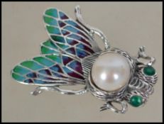 A silver plique a jour bug brooch in the form of a fly with large central freshwater pearl to centre
