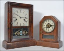 Two early 20th century American gingerbread clocks. Both with inset 8 day movement having glass
