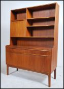 A 1970's McIntosh of Kirkcaldy teak wood sideboard room divider cabinet having a shaped cabinet with