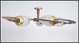 A vintage retro 20th century teak wood fan and five point  light fixture having conical class