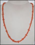 A vintage red branch coral necklace with yellow metal clasp together with another coral necklace