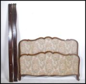 An early 20th century French corbeille upholstered bed having chenille fabric head and footboard
