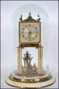 A German brass anniversary clock, with art deco characters and a glass dome.  Needs some care and
