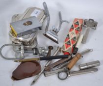 A collection of items to include Rolls Razors, vesta, hair clippers, a fantastic lighter in the form
