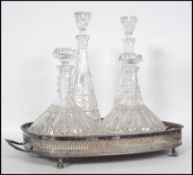 A pair of cut glass ships decanters both with stoppers together with another pair of tall tapering