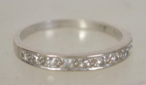 An 18ct white gold and diamond ladies half eternity ring. The round cut diamonds  being channel set.