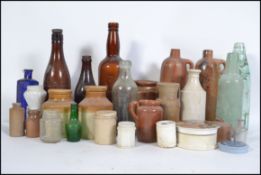 A collection of vintage collectable bottles of local interest, relish pots being dug from the