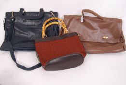 A collection of three vintage ladies bags / handbags. One navy leather attache style bag with