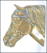 Heavy cast brass horses head from the early 20th century.  A hollow piece which can be wall mounted.