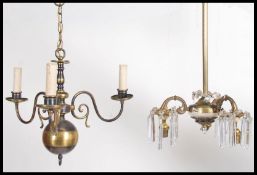A vintage 20th century brass and glass luster droplet chandelier togther with another.