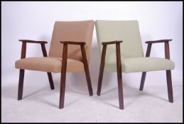 A pair of retro mid century Danish carver armchairs raised on a-frame teak wood supports with