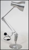 A contemporary polished steel desk lamp by Anglepoise lamp Co. Raised on a circular base having a