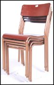 A stack of 4 vintage mid century Industrial stacking chairs having enamel painted tubular metal