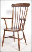 A Victorian beech and elm windsor armchair - chair being raised on turned legs united by