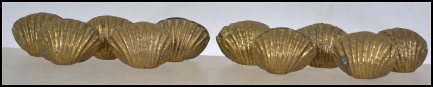 A collection of ten scalloped bronzed table name / menu setting holders. Measures 3cm wide.