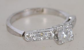 An 18ct white gold and diamond ring having large central round cut stone approx 50-60pnts  with