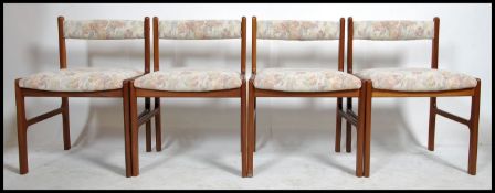 A 1970's set of 4 retro Danish inspired teak wood dining chairs having chamfered edge frames with