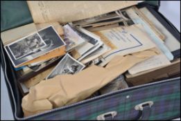 Attic clearance suitcase bursting with photographs, stamp albums, paperwork, postcards, ephemera