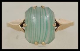 A ladies 9ct gold single stone dress ring with unusual agate stone centre of lined form, the shank