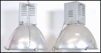 A pair of 20th century Industrial Hillclare factory pendant lights having half sphere polished