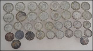 A group of 20 pre 1947 George V one florin coins along with a group of 20 George V one shilling