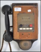 A vintage 20th century GEC wall mounted telephone being wooden cased with bell and mounted plaque