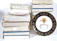 A collection of boxed collectors plates various different designs and makers