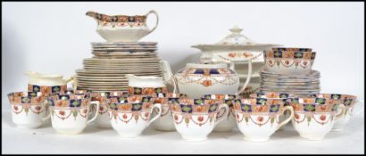 A 20th century Imari pattern Staffordshire part dinner and  tea service comprising teapot, sugar