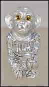 A silver 925 and silver plate pin cushion in the form of a monkey having a red baize cushion to
