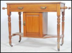 An Edwardian walnut hall table with central locker cupboard and short drawer with brass handles