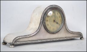 A silver plated Napoleon mantle clock the  enamel dial with Arabic numerals and a French made